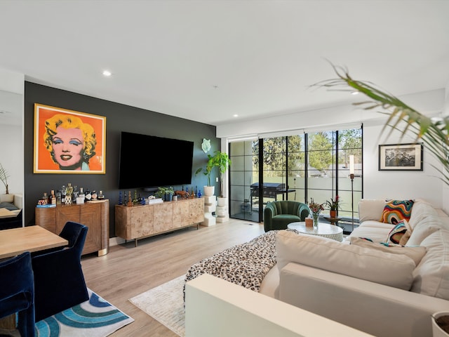 living room featuring light wood finished floors and recessed lighting