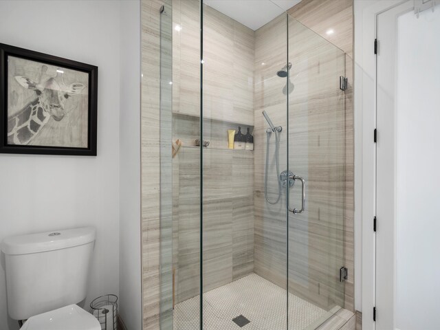 full bathroom with a shower stall and toilet