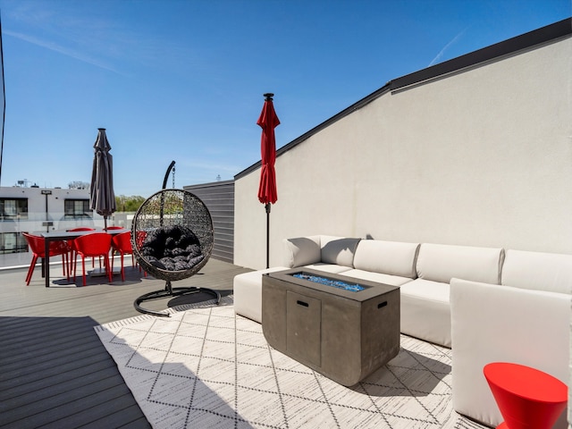 view of patio / terrace with an outdoor living space with a fire pit and outdoor dining area