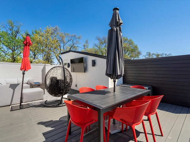 deck with outdoor dining area