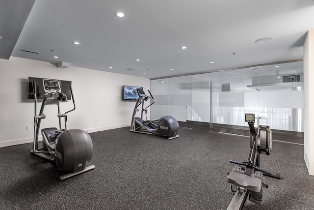 gym featuring baseboards, recessed lighting, and visible vents