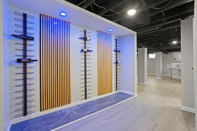 interior space with baseboards, recessed lighting, and wood finished floors