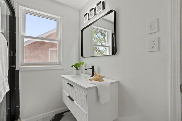 bathroom featuring baseboards, marble finish floor, and vanity