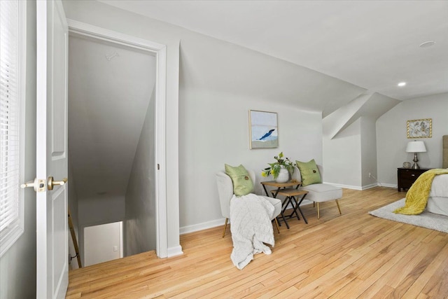 living area featuring vaulted ceiling, wood finished floors, baseboards, an upstairs landing, and recessed lighting