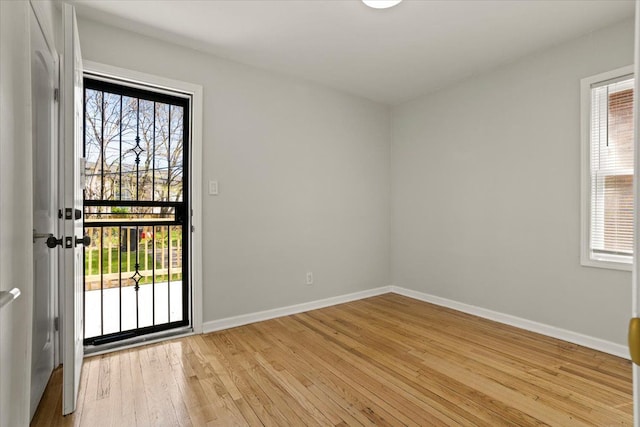 entryway featuring baseboards and light wood-type flooring