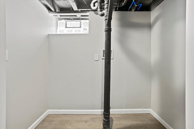 below grade area with baseboards and wood finished floors