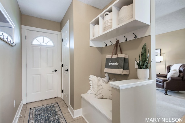 mudroom featuring baseboards and light tile patterned floors