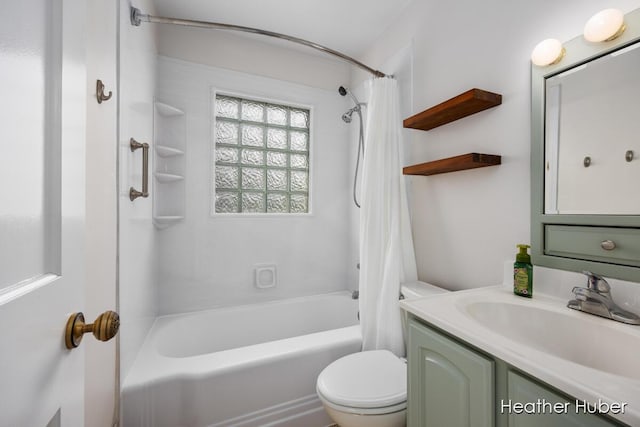 bathroom featuring vanity, shower / tub combo with curtain, and toilet