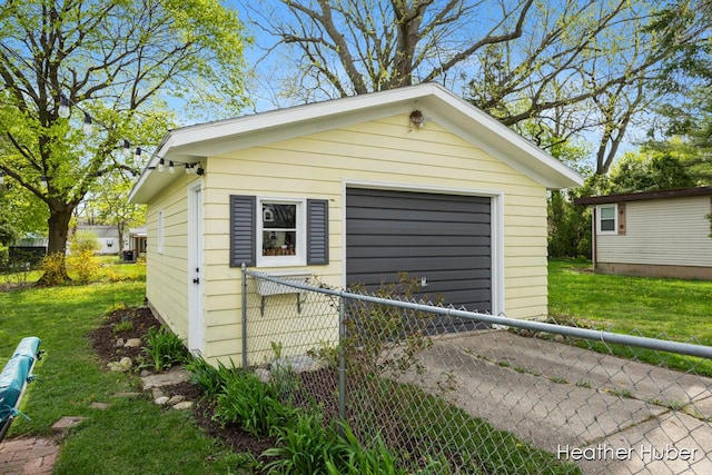 detached garage with fence and driveway
