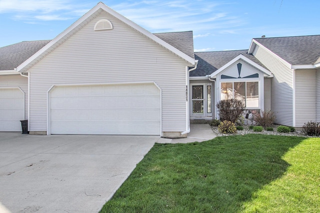 single story home featuring driveway, a front lawn, roof with shingles, and a garage