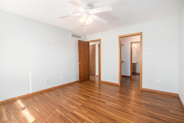unfurnished bedroom with visible vents, a ceiling fan, baseboards, and wood finished floors