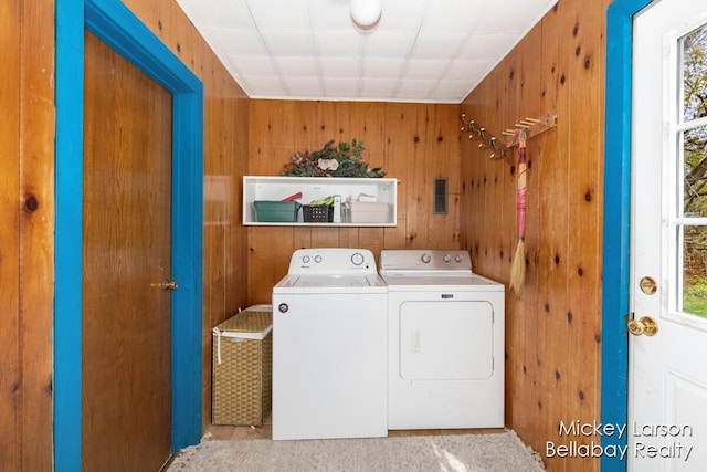laundry room with wooden walls, plenty of natural light, laundry area, and independent washer and dryer