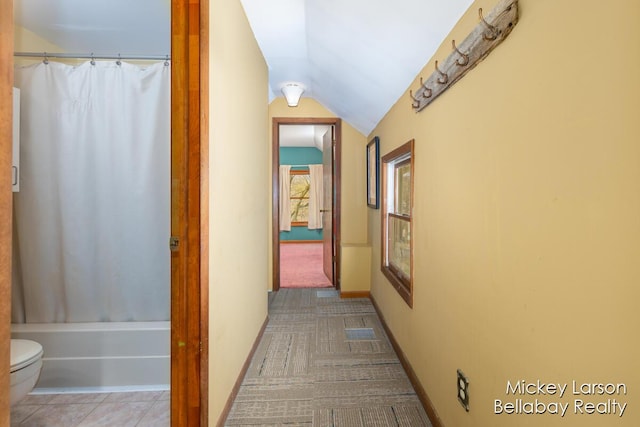 hall with vaulted ceiling