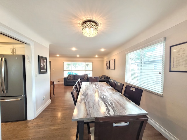 dining room featuring an inviting chandelier, baseboards, recessed lighting, and dark wood finished floors
