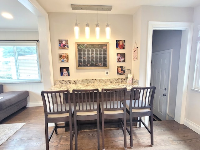 dining area featuring baseboards and wood finished floors