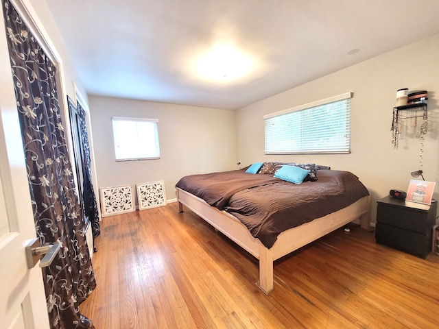 bedroom featuring baseboards and wood finished floors