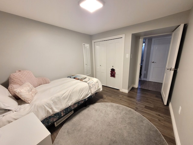 bedroom featuring baseboards and wood finished floors