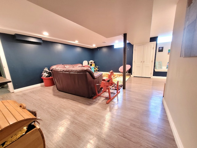 interior space with baseboards, recessed lighting, and wood finished floors