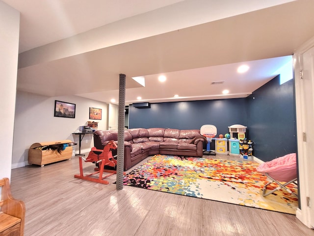 living room with baseboards, recessed lighting, wood finished floors, and visible vents