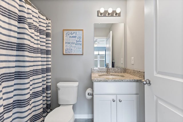 bathroom featuring toilet, a shower with curtain, and vanity