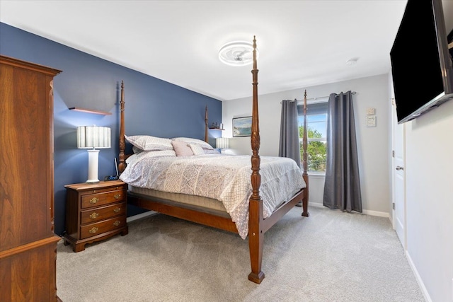 bedroom featuring light colored carpet and baseboards