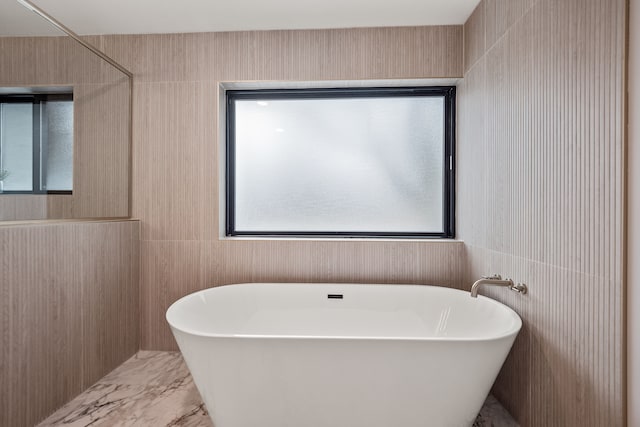 21725 Normandale St, Beverly Hills, MI 48025 - bathroom with a freestanding bath, marble finish floors, and tile walls