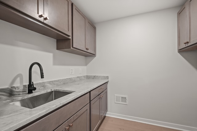21725 Normandale St, Beverly Hills, MI 48025 - kitchen with a sink, light wood-type flooring, baseboards, and light countertops