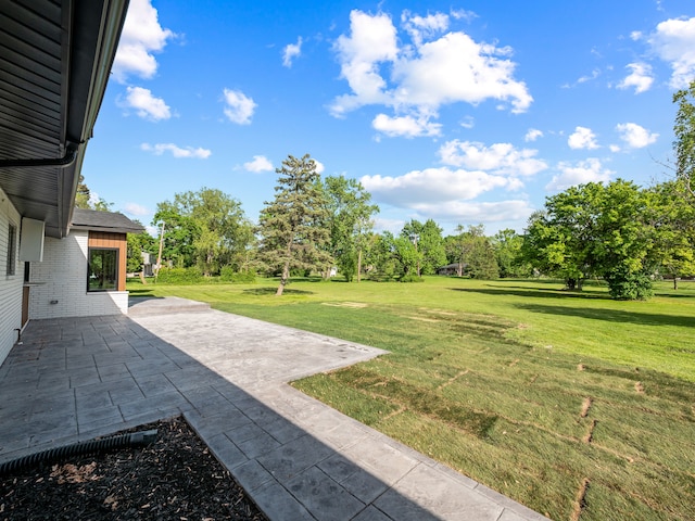 21725 Normandale St, Beverly Hills, MI 48025 - view of grassy yard featuring a patio area and view of wooded area