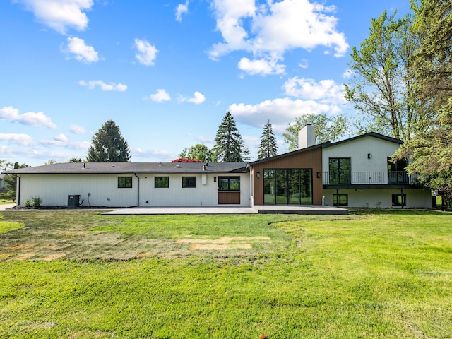 21725 Normandale St, Beverly Hills, MI 48025 - back of house with a chimney, a lawn, and a patio