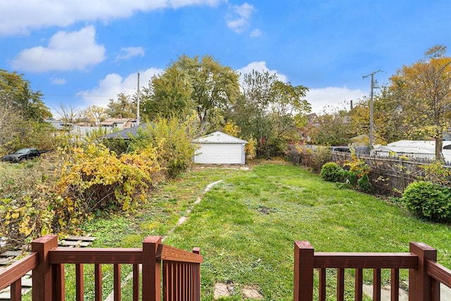 view of yard with fence and a detached garage