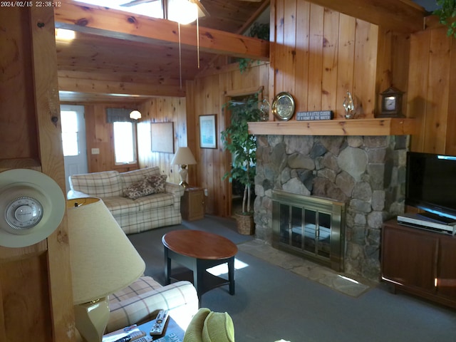 2305 Ridge Rd, White Lake, MI 48383 - carpeted living area featuring wood walls, a stone fireplace, beamed ceiling, wood ceiling, and a ceiling fan