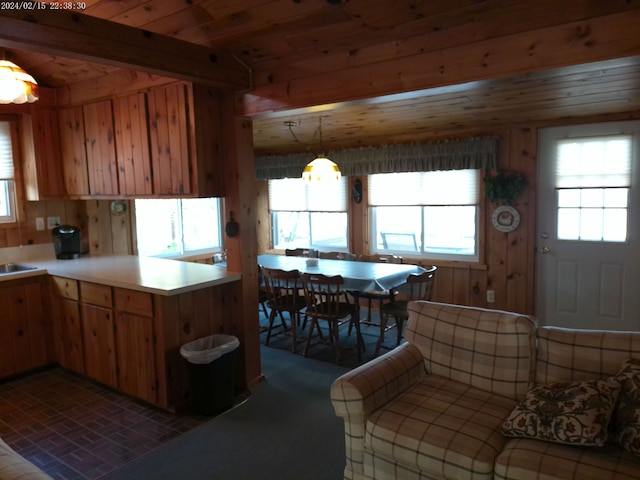 2305 Ridge Rd, White Lake, MI 48383 - kitchen featuring plenty of natural light, light countertops, a peninsula, brick patterned floors, and wooden walls