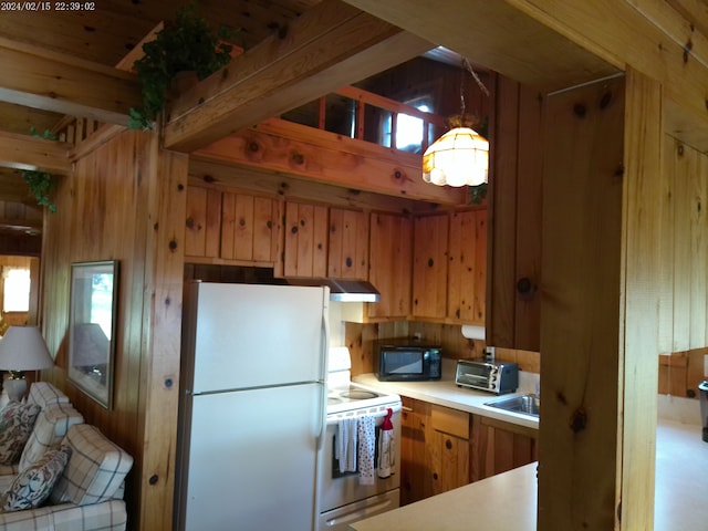 2305 Ridge Rd, White Lake, MI 48383 - kitchen featuring white appliances, light countertops, a chandelier, wooden walls, and brown cabinetry