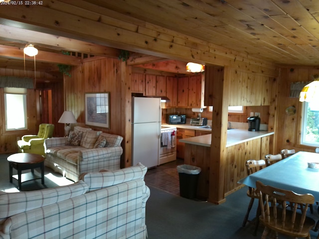 2305 Ridge Rd, White Lake, MI 48383 - kitchen featuring white appliances, light countertops, wooden walls, wood ceiling, and brown cabinets