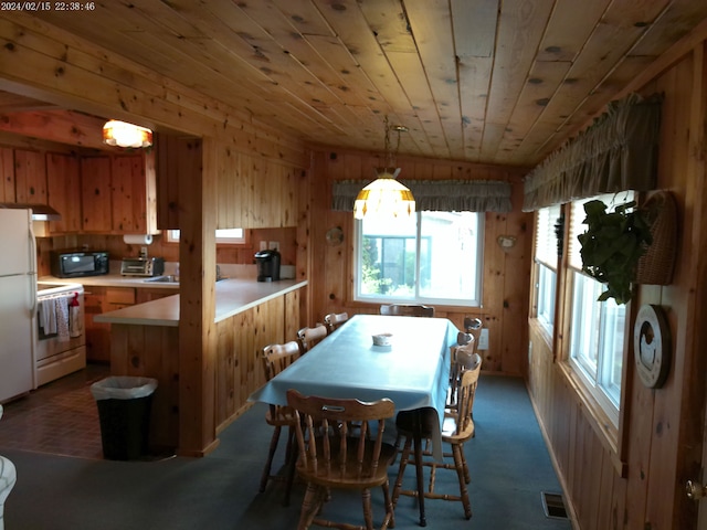 2305 Ridge Rd, White Lake, MI 48383 - dining space with wooden ceiling, wooden walls, and dark carpet