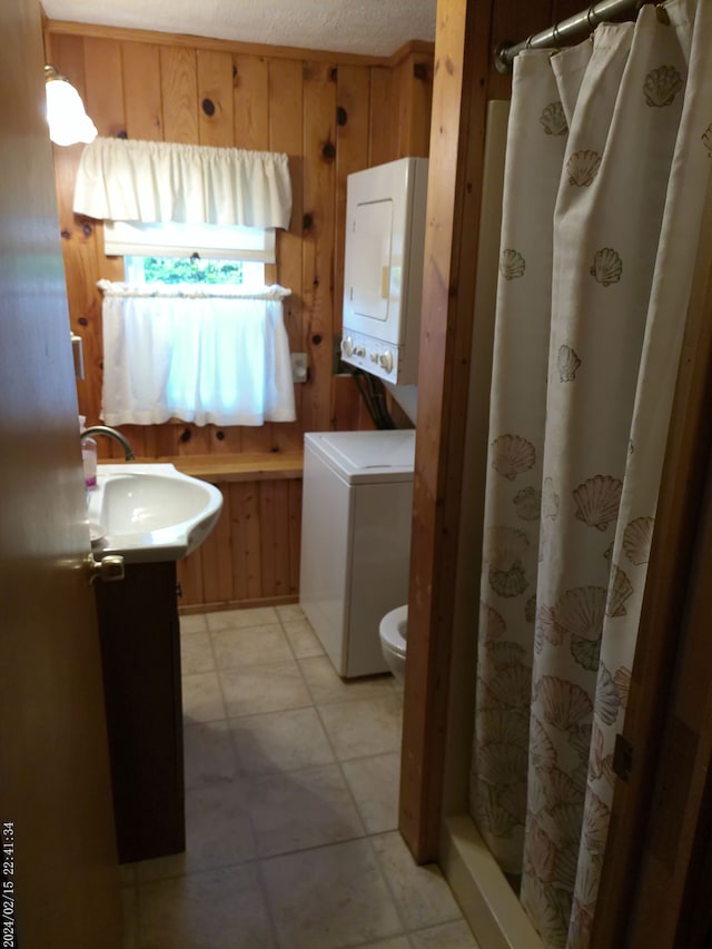 2305 Ridge Rd, White Lake, MI 48383 - full bathroom featuring stacked washer and clothes dryer, wooden walls, curtained shower, toilet, and vanity