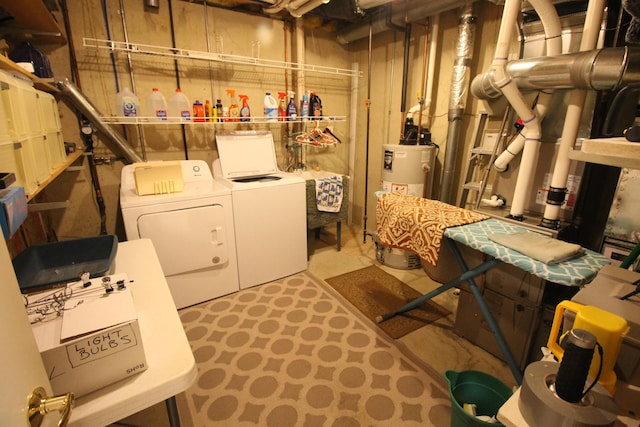 laundry area with washer and dryer, laundry area, and water heater