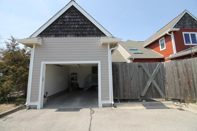 garage with fence and driveway