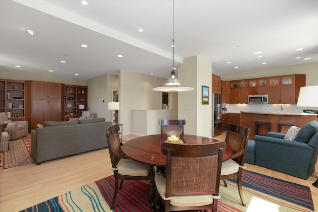 dining space with recessed lighting and light wood-type flooring