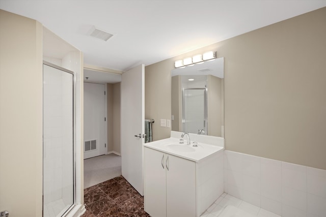 full bathroom featuring vanity, visible vents, and a stall shower