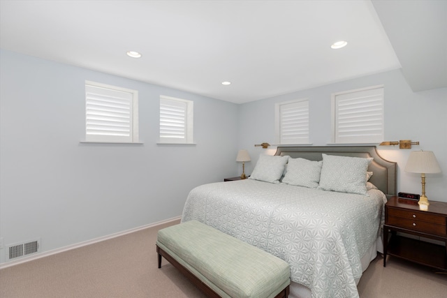 carpeted bedroom featuring recessed lighting, baseboards, and visible vents
