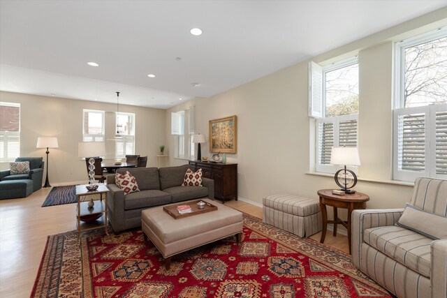 living area with recessed lighting, wood finished floors, and a wealth of natural light
