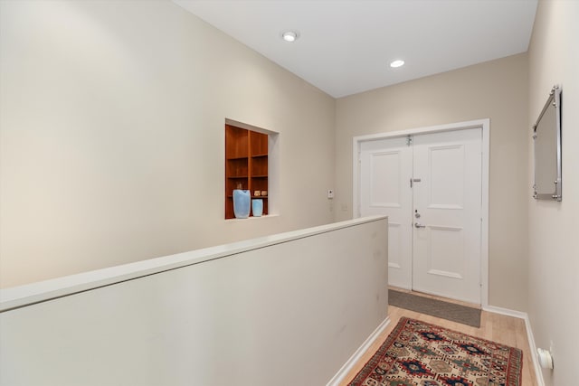 doorway with recessed lighting, baseboards, and light wood-type flooring