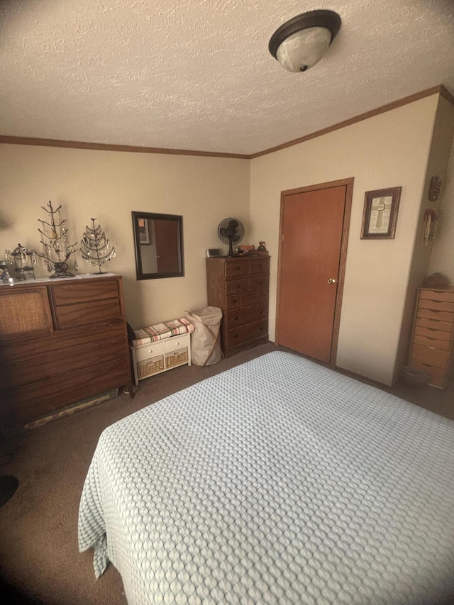 bedroom featuring crown molding, a textured ceiling, and carpet