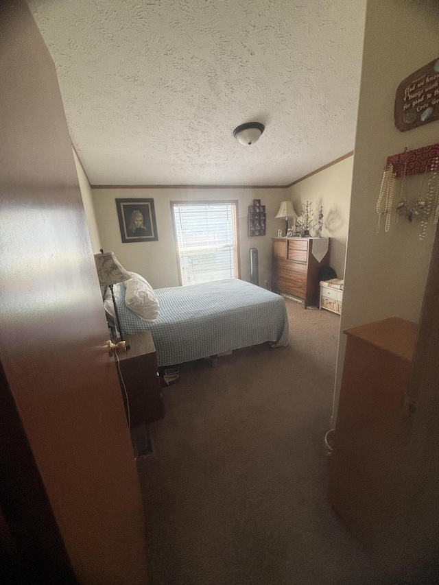 bedroom with carpet floors and a textured ceiling