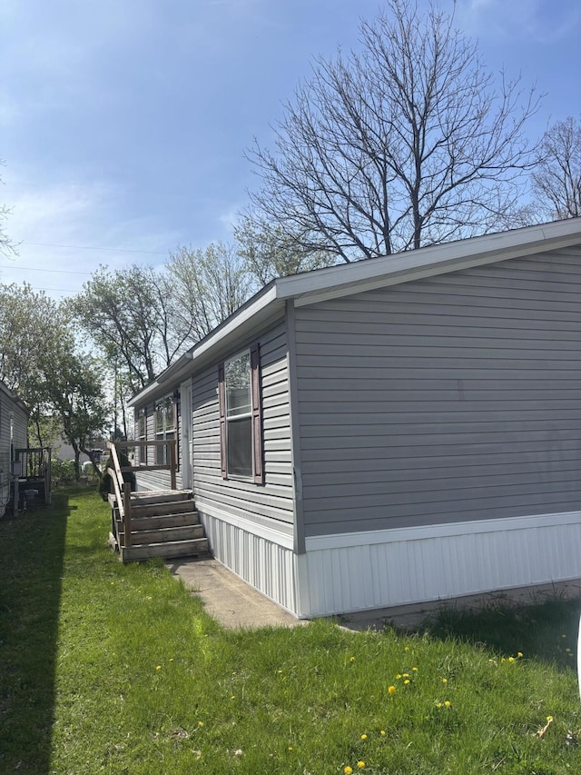 view of side of property with a lawn