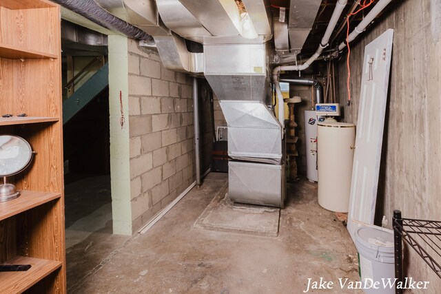 unfinished below grade area featuring water heater