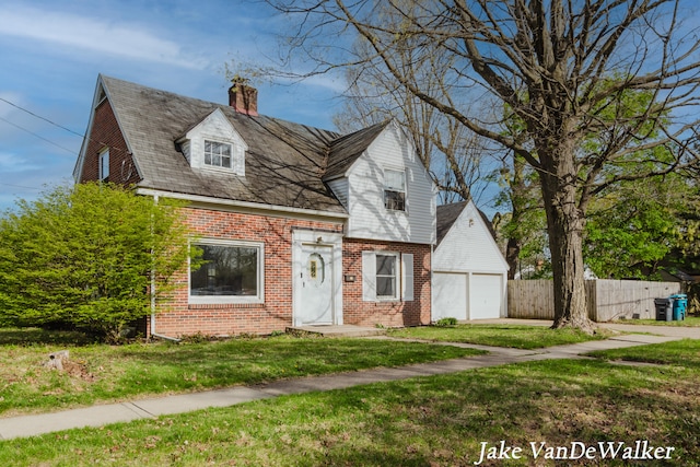 cape cod home with brick siding, fence, a front yard, and a chimney