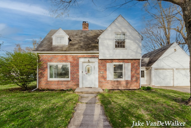 new england style home featuring an attached garage, a chimney, a front yard, and brick siding