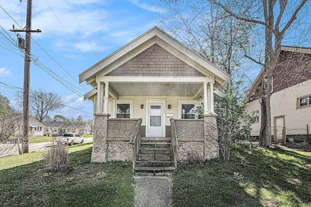 view of front of house with covered porch and a front yard
